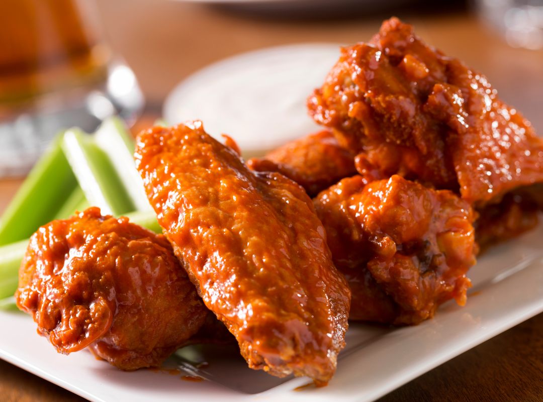 Bogey's Wing Wednesday – Best Wings in Venice FL Sauced chicken wings with celery and blue cheese dipping sauce served at Bogey's Sports Pub in Venice, FL
